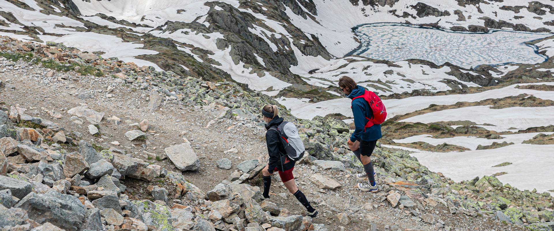 Couple walking in the mountains with high knee socks.