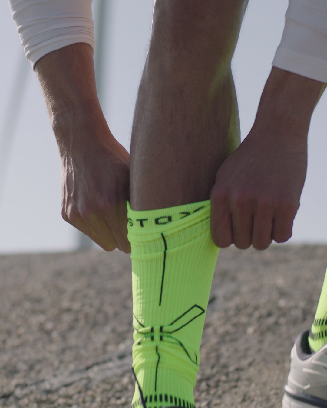 Two people running with colorful socks on. 